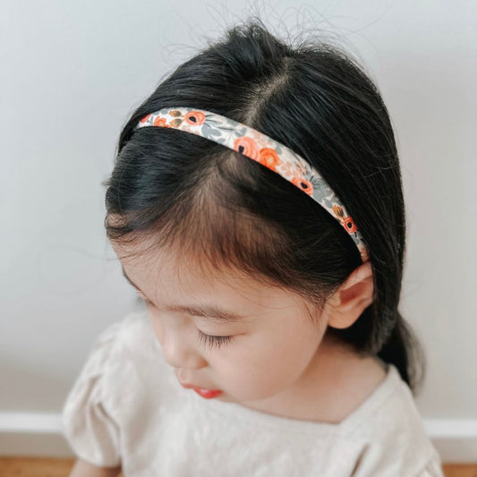 Girl with dark hair wearing the Anna Alice headband