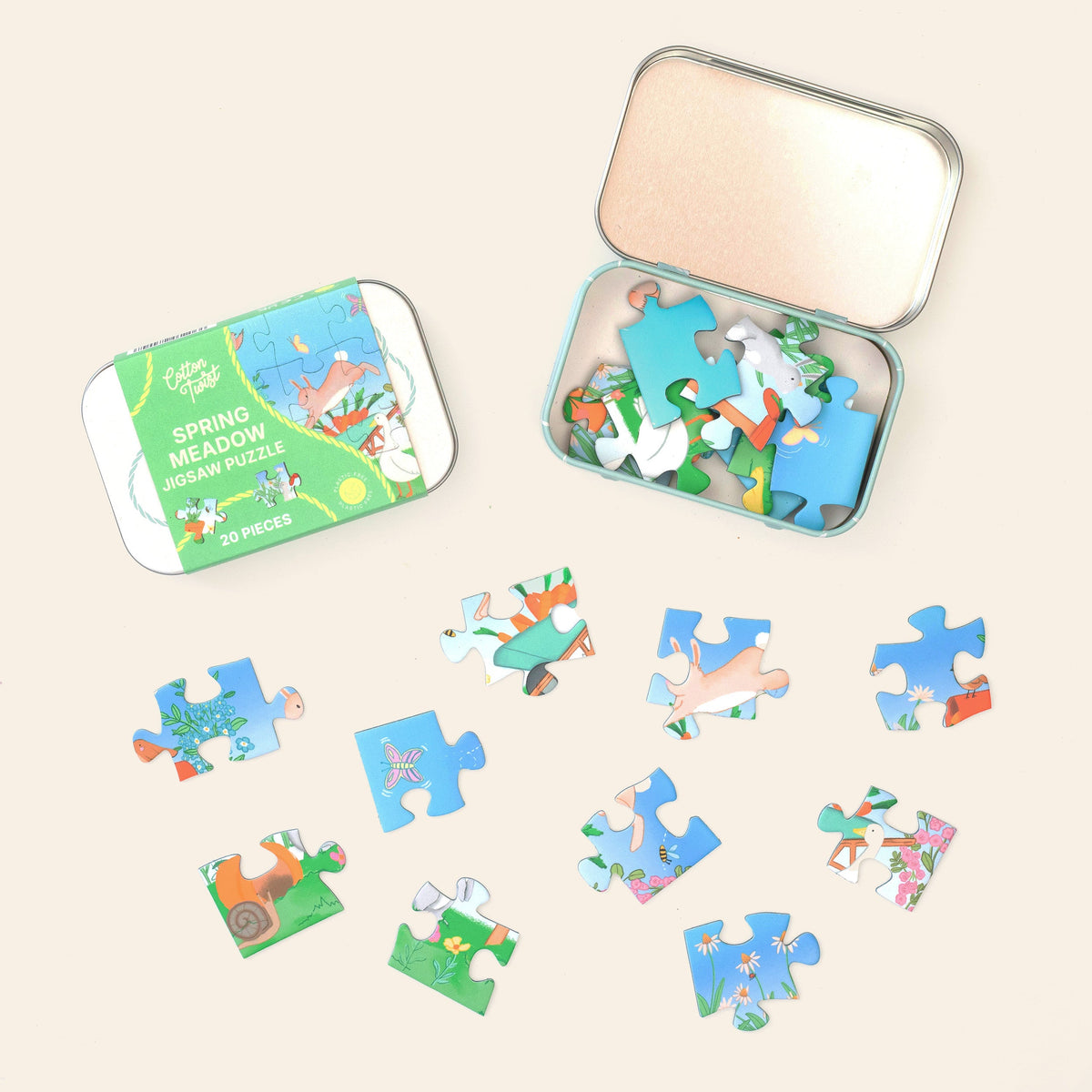 Spring Meadow mini jigsaw pieces laid out beside the open tin