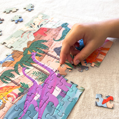 Child fitting pieces into the Dinosaur World 100-piece jigsaw