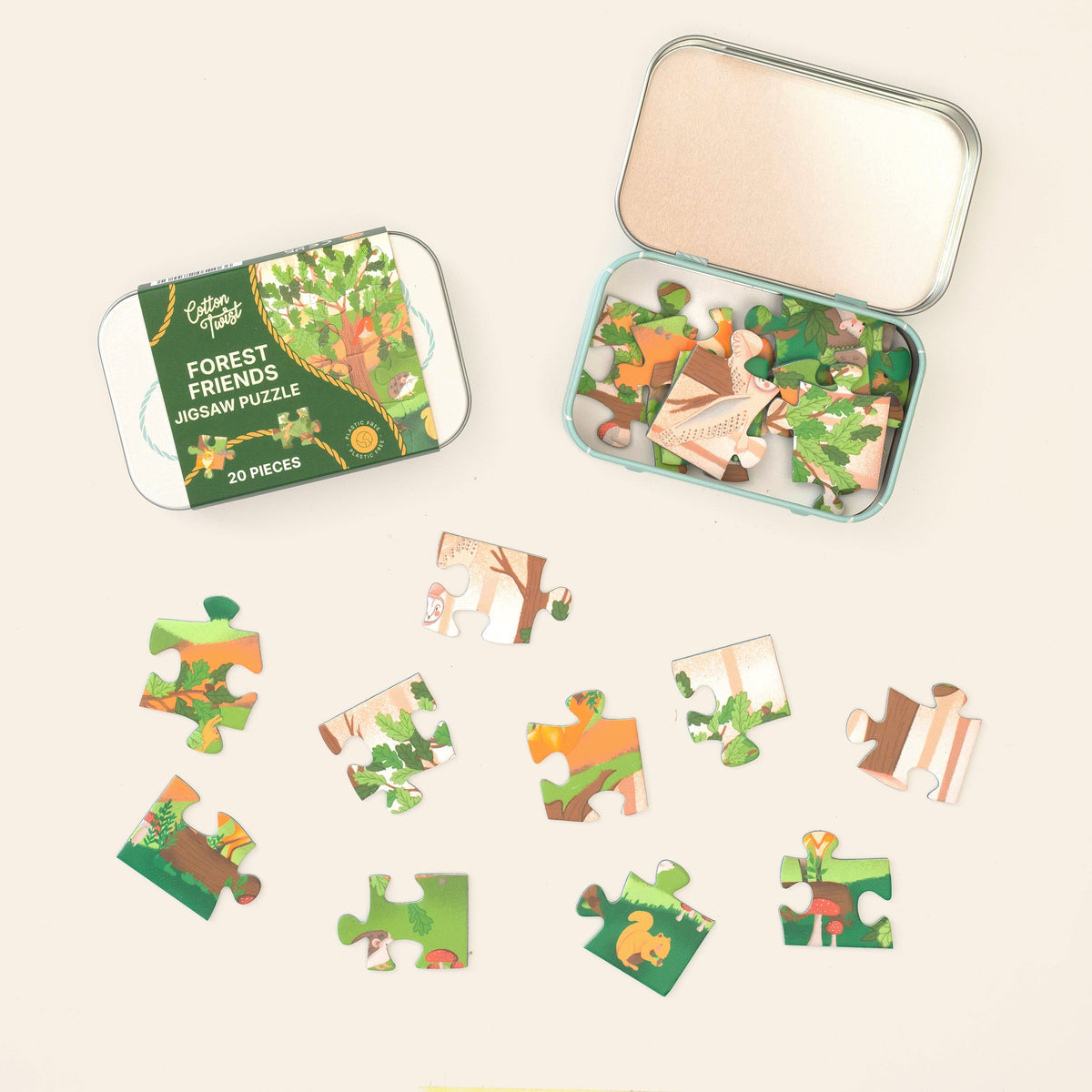 Forest Friends mini jigsaw pieces laid out beside the open tin