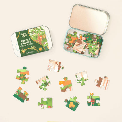 Forest Friends mini jigsaw pieces laid out beside the open tin