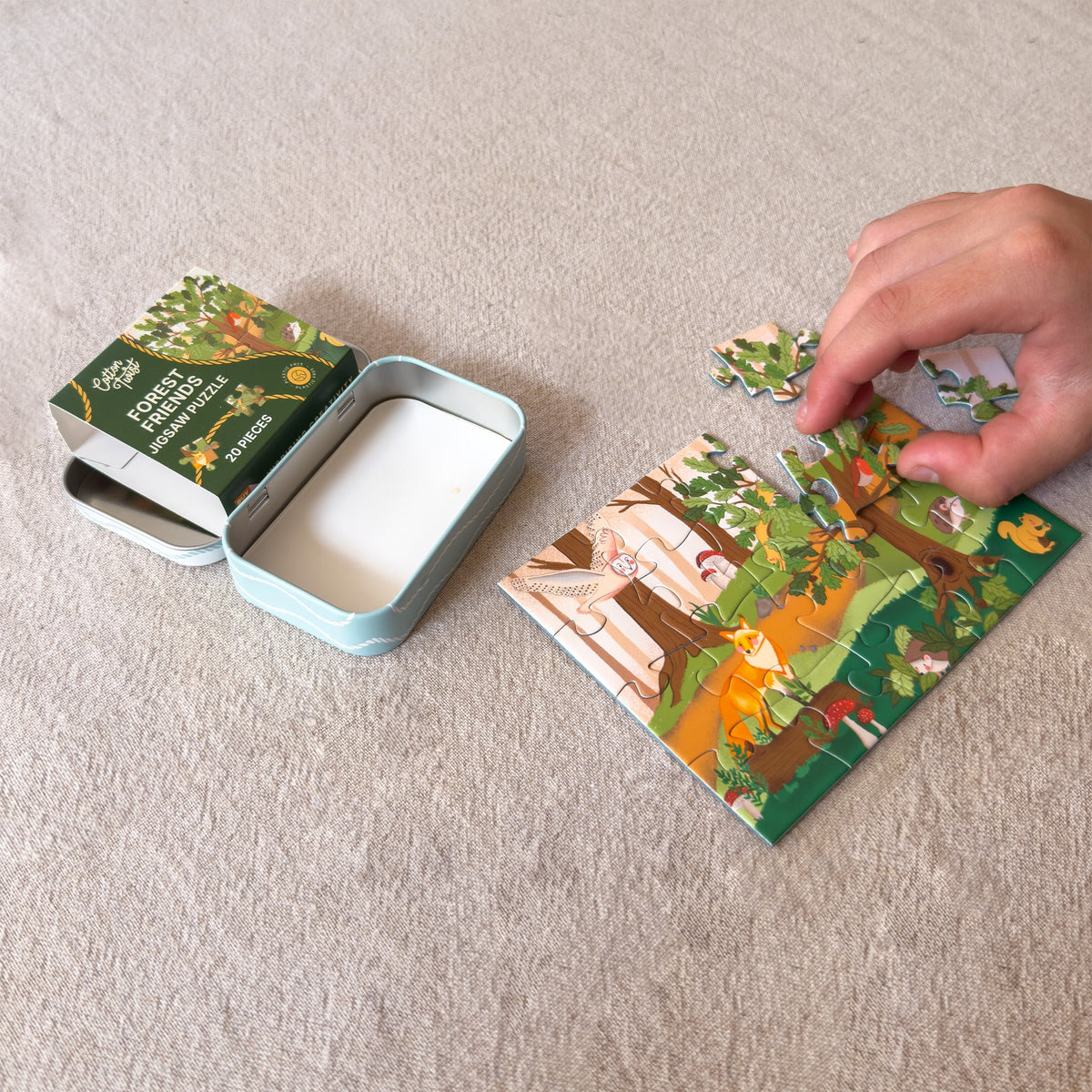Child piecing together the Forest Friends mini jigsaw puzzle