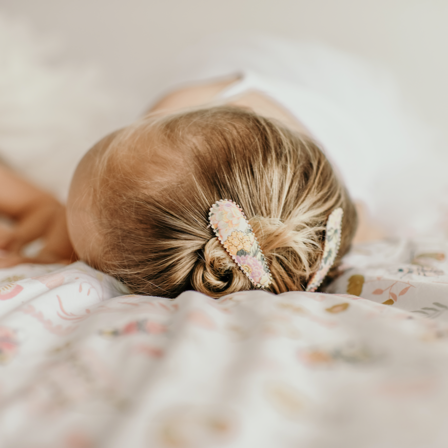 Sleeping baby wearing Josie Joan's Audrey hair clips