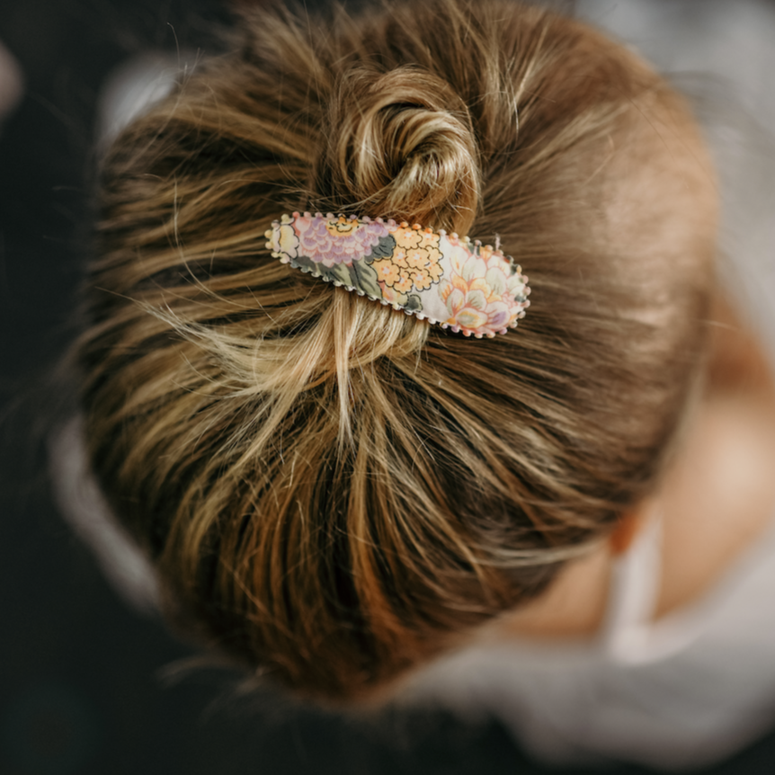 Josie Joan's Audrey hair clip holding back a child's top knot