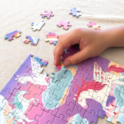 Child fitting pieces into the Unicorn Dreamland 100-piece jigsaw