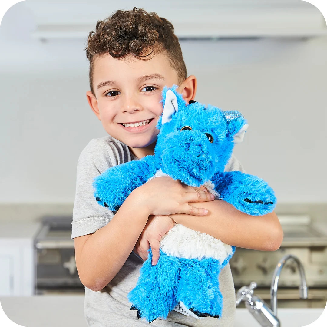 Child hugging a Warmies blue dragon microwavable lavender plush toy