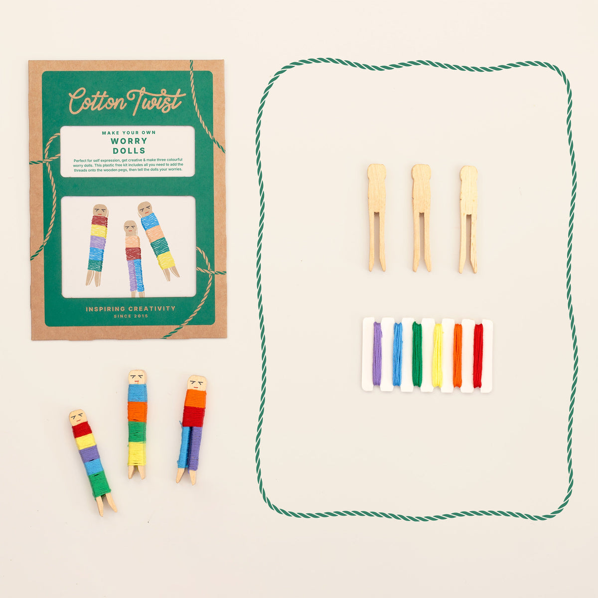 Worry dolls kit contents with wooden peg dolls and coloured cotton thread